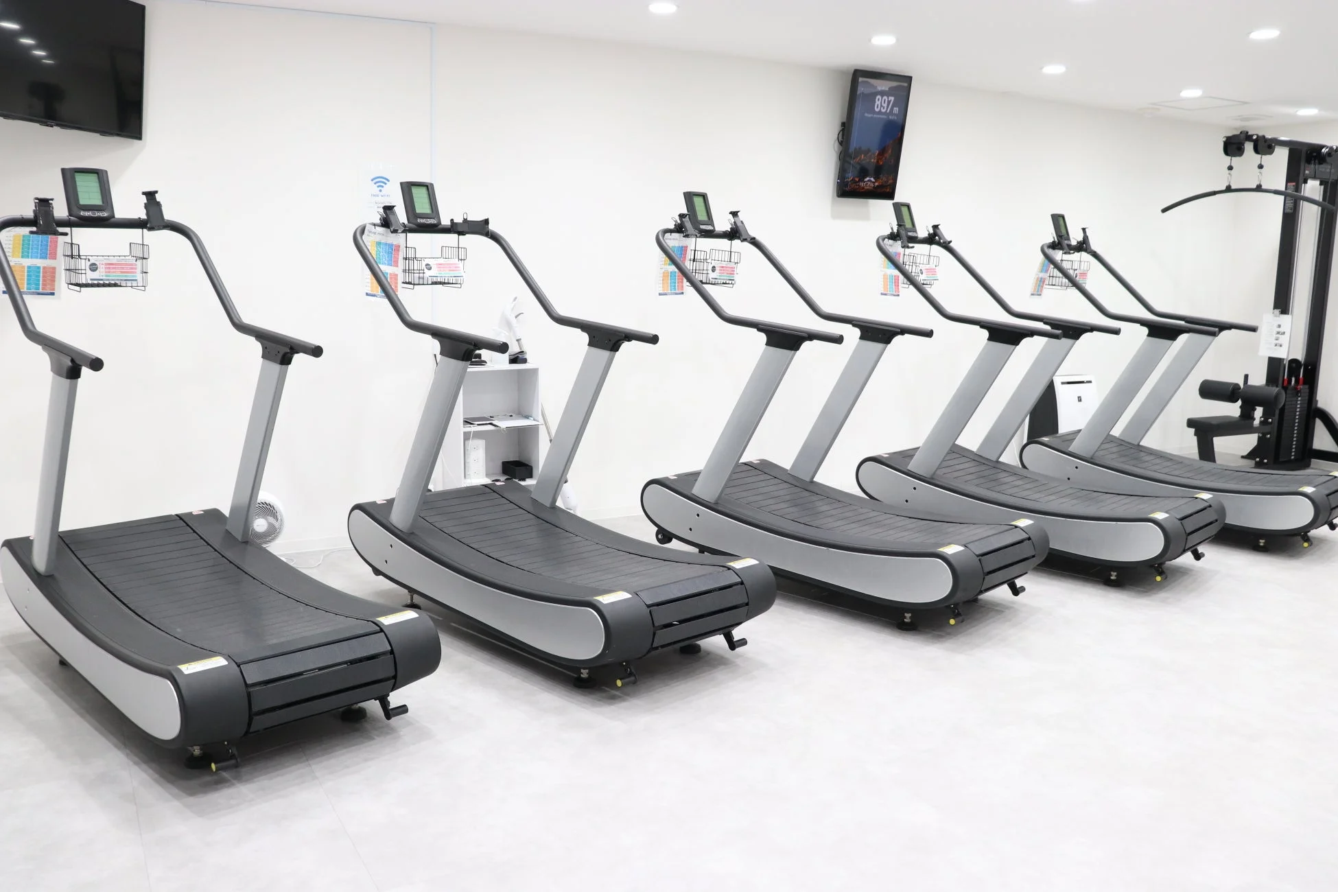 明るく清潔な室内フィットネスジムのトレッドミル