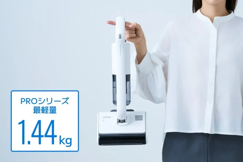 女性が白い軽量スティック掃除機を持っている画像