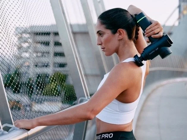 女性がマッサージガンを使用