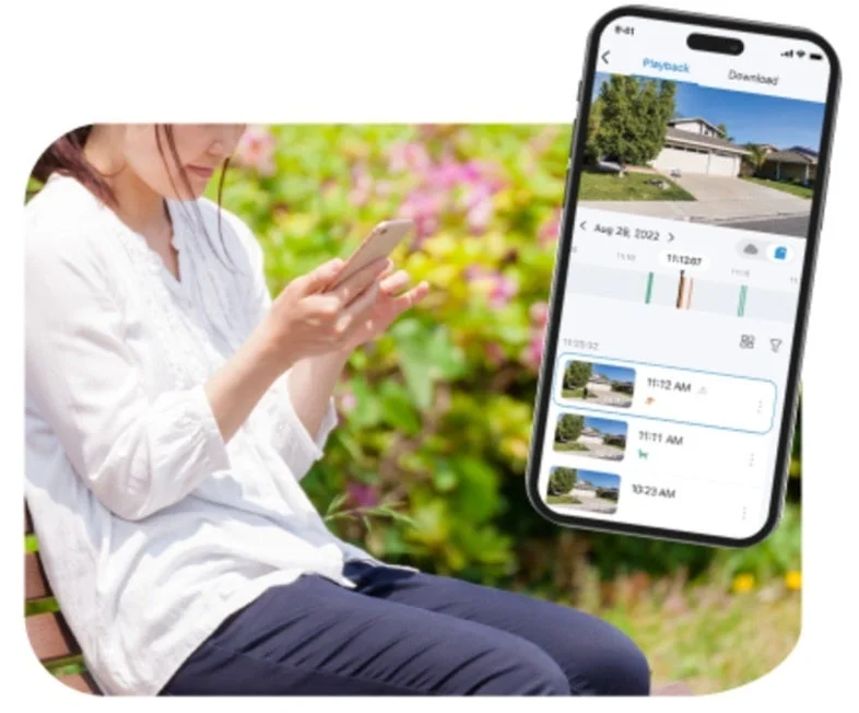 スマートフォンで防犯カメラ映像を確認する女性