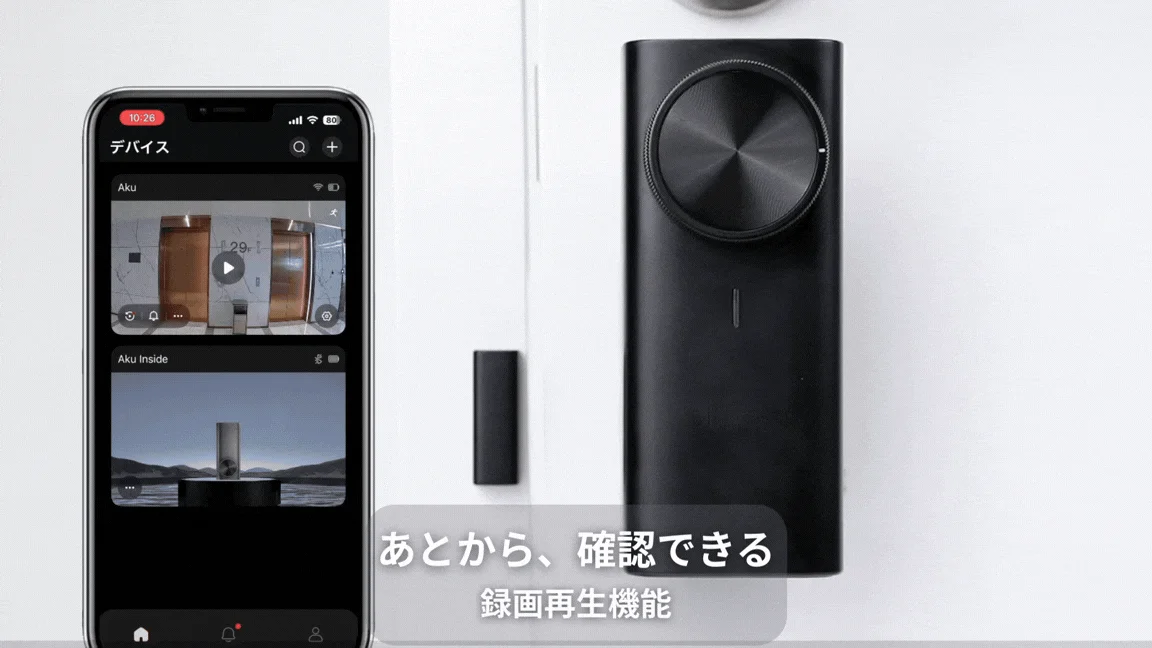 スマートフォンで監視カメラアプリの画面を表示し、黒いスマートデバイスと共に録画再生機能を紹介しています