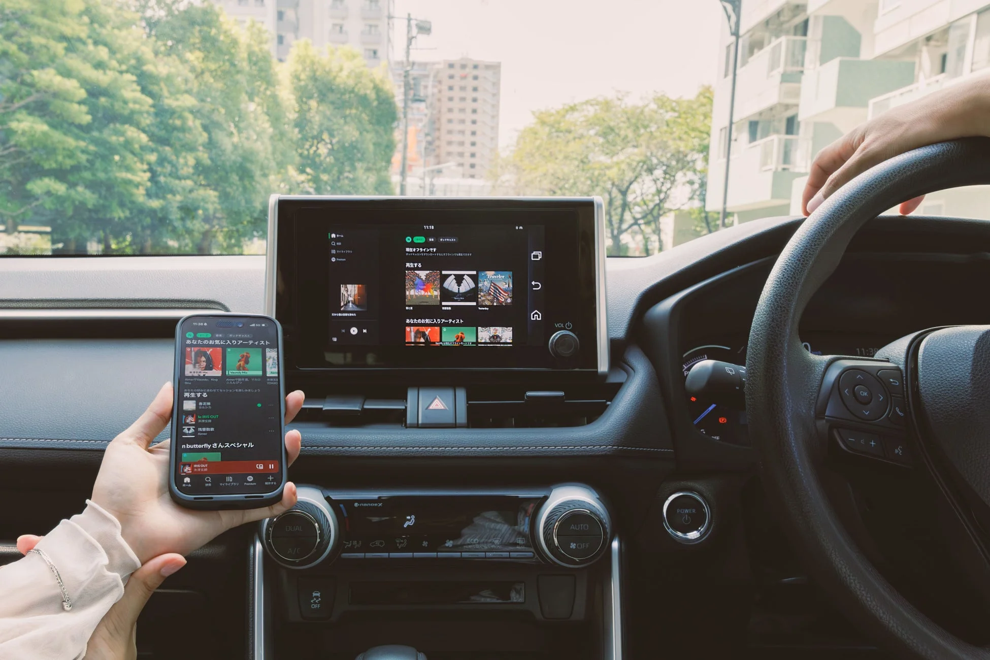 車内でカーナビ画面にSpotifyアプリが表示され、音楽を楽しんでいる様子