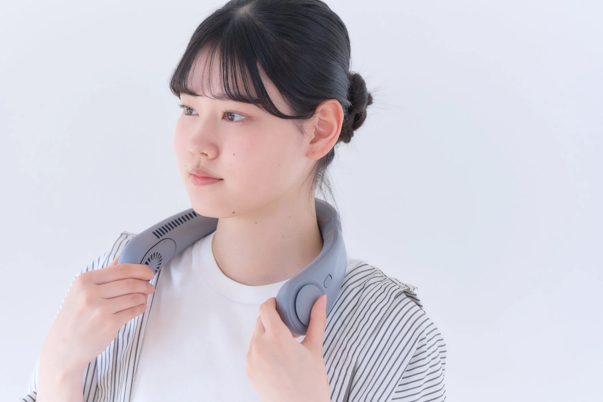 首掛け扇風機を着用した女性の横顔