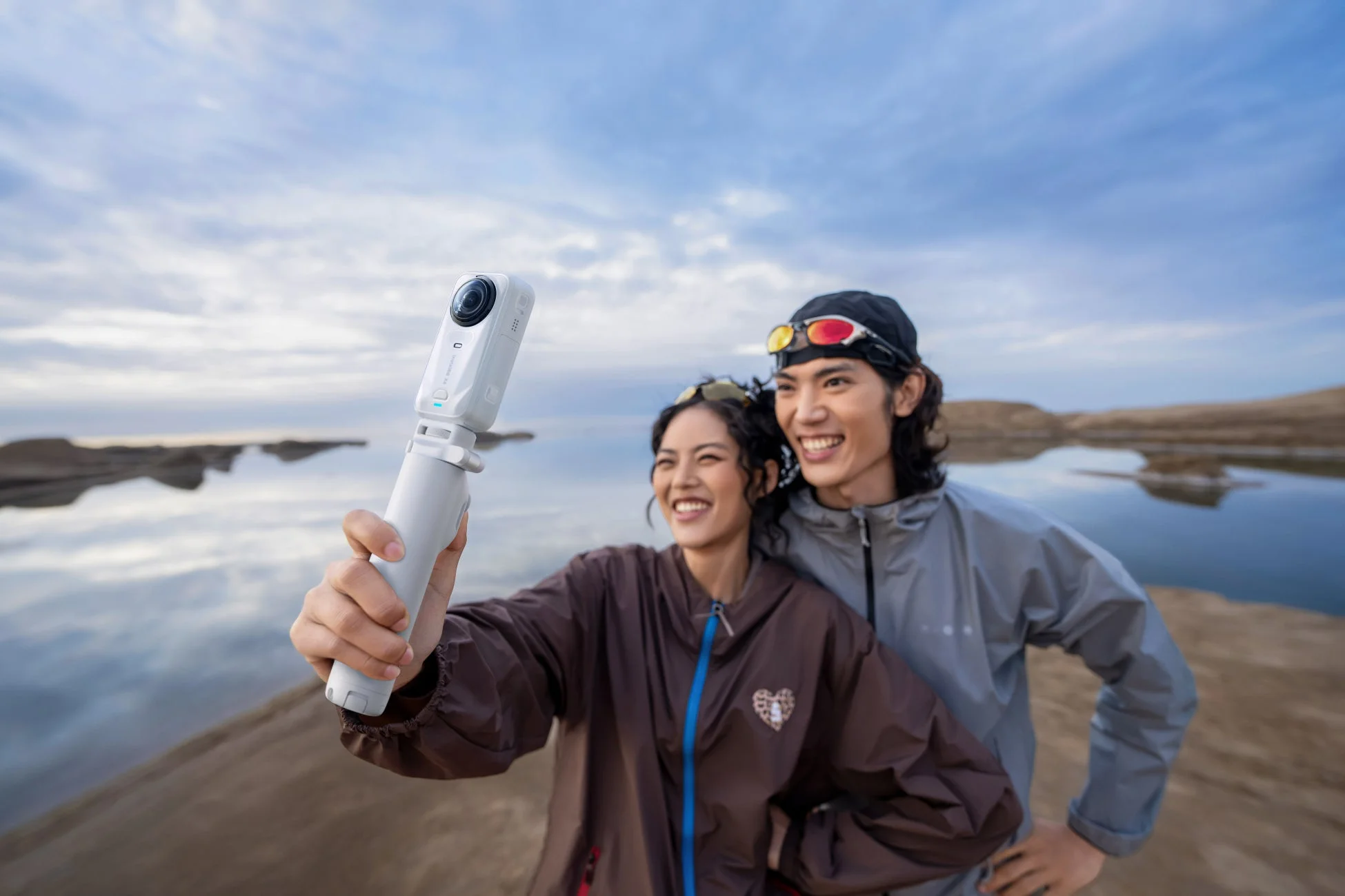 湖畔で撮影するカップル
