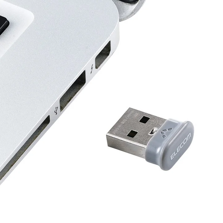 ノートパソコンのUSBポートに挿された小型USBアダプタ