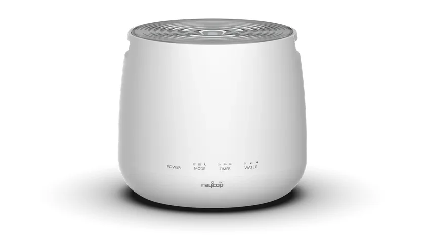 白い背景に、raycopブランドの白い卓上型家電が写っています。天面は波紋状で、前面には電源、モード、タイマー、水量の操作表示と「raycop UV+」のロゴがあります。加湿器や空気清浄機として使われるシンプルなデザインの製品です。